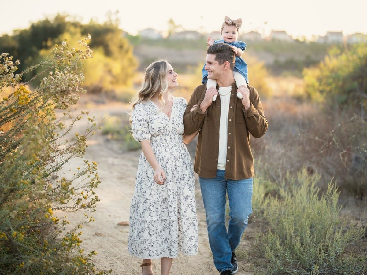 A young family walking together in golden light